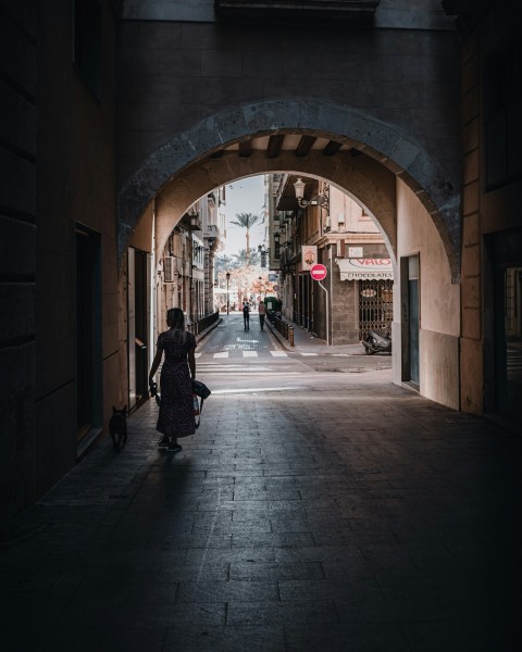 a woman walking down a dark alley way nD