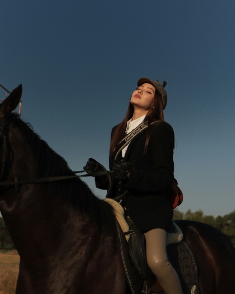 a person standing next to a horse