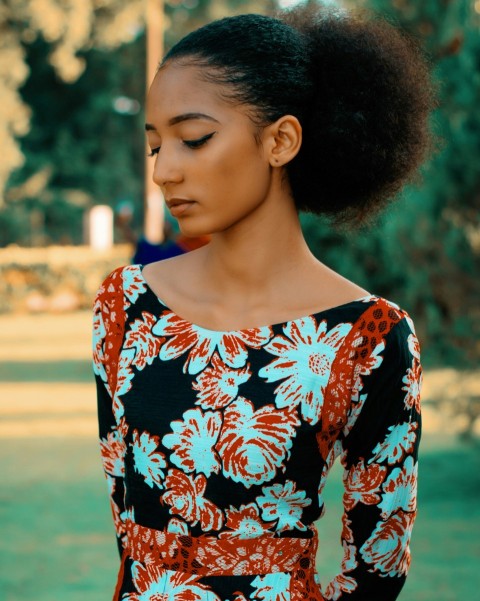 woman wearing black white and orange floral dress