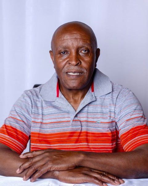 man in red and white striped polo shirt