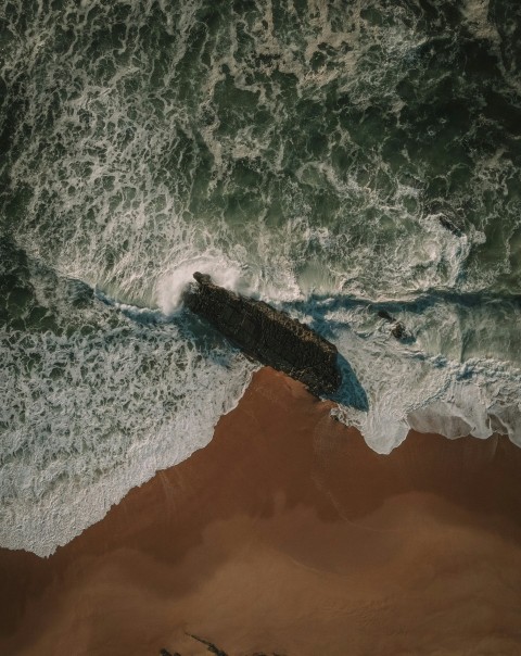 blue water waves on black and gray rock