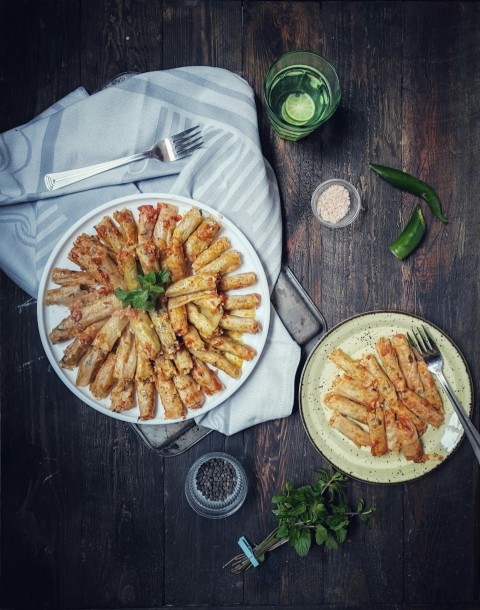 sliced pie on white ceramic plate beside stainless steel fork and knife kq