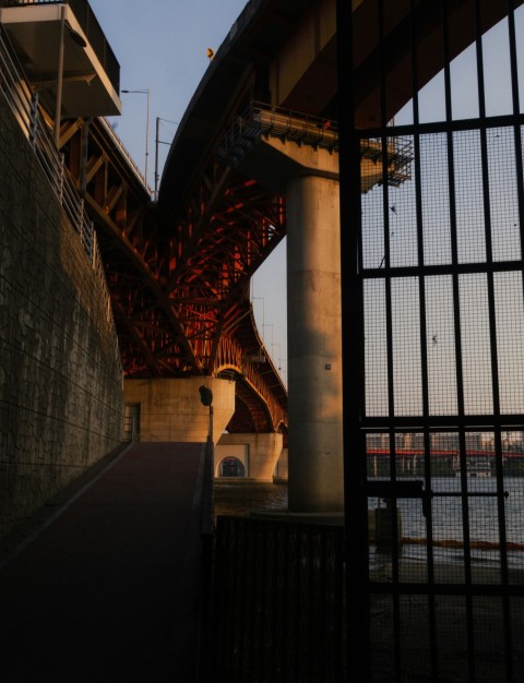 a view of a bridge from behind a fence