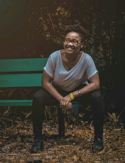 man in gray crew neck t shirt sitting on brown wooden bench