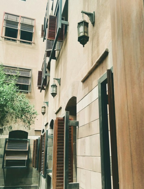 a building with a bunch of windows and shutters T XoCFc