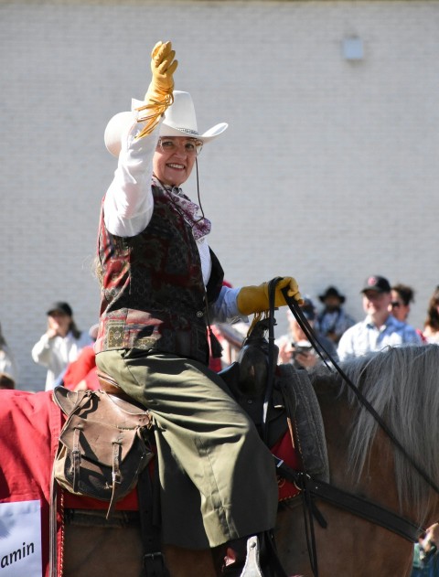 a man riding on the back of a brown horse