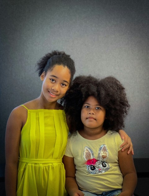 two young girls posing for a picture together