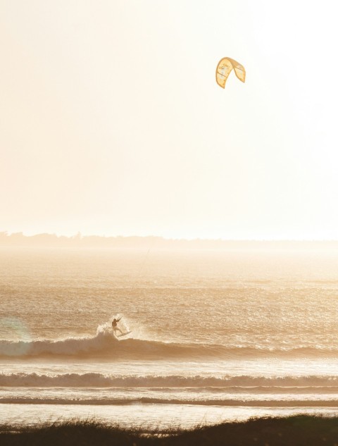 a person riding a surfboard on top of a wave