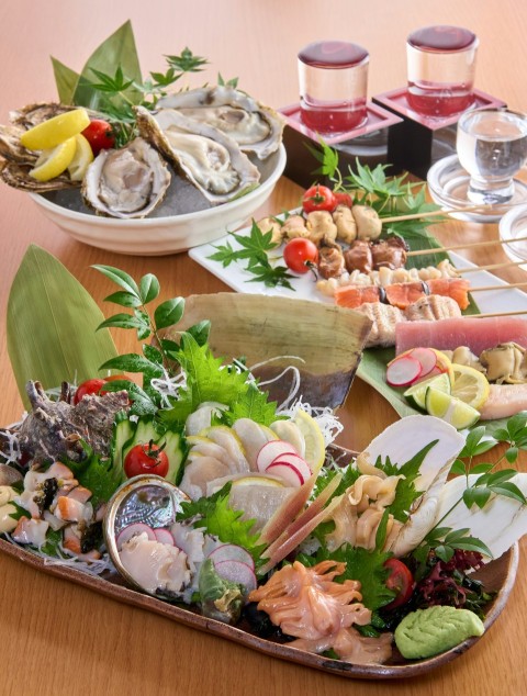 a wooden table topped with plates of food