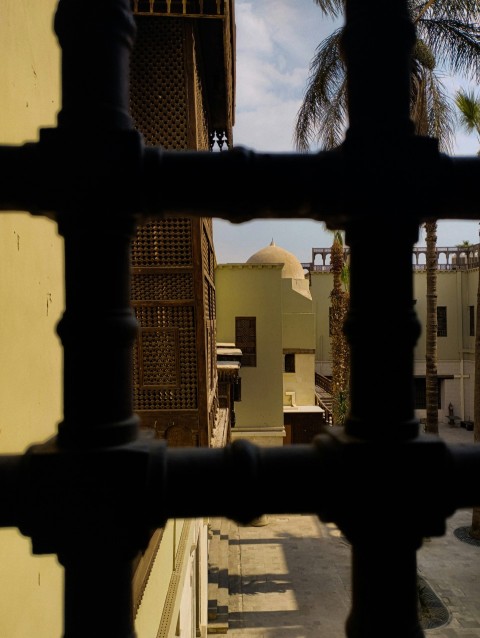 a black pipe with a building in the background