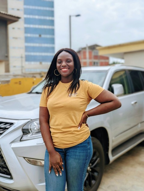 a woman standing in front of a car