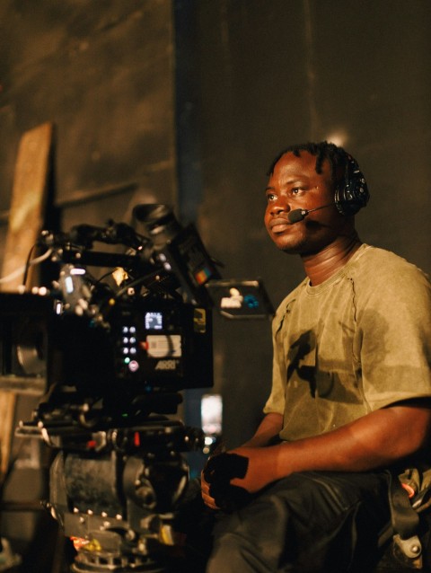 a man sitting in front of a camera qu