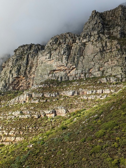 a large mountain with a very tall mountain in the background