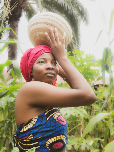 a woman holding a coconut