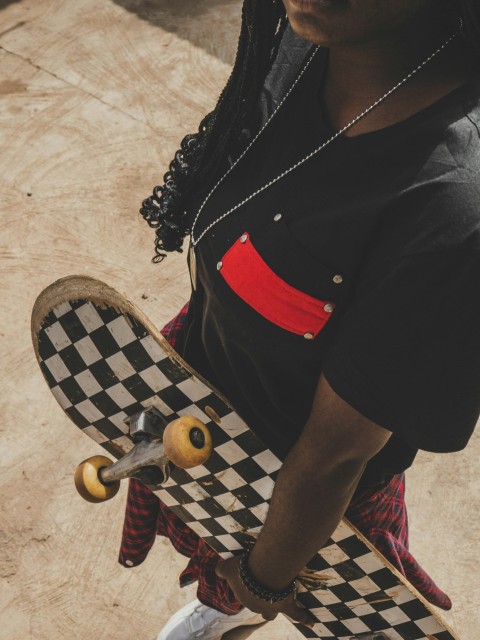 woman in black shirt and red skirt wearing brown woven hat