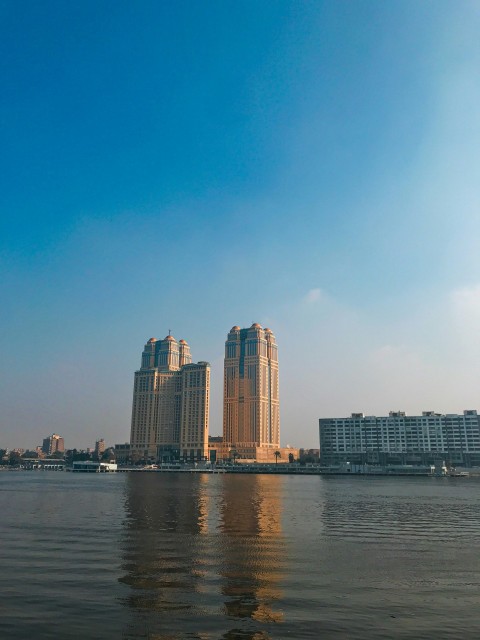 city skyline across body of water during daytime