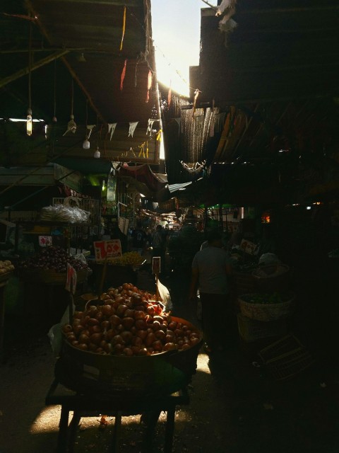 a market with a lot of produce and people