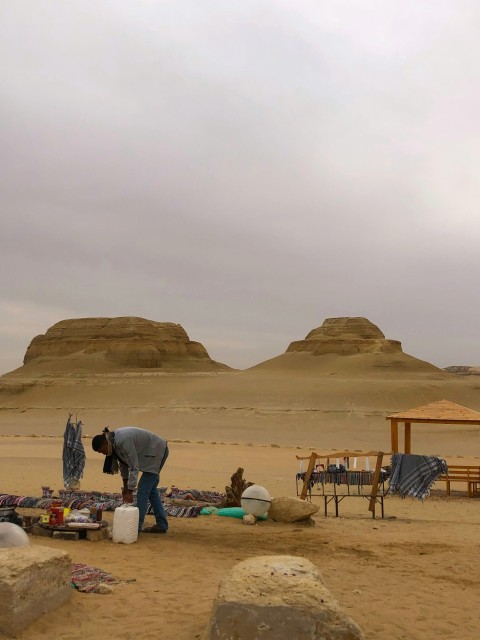 a man standing in the middle of a desert