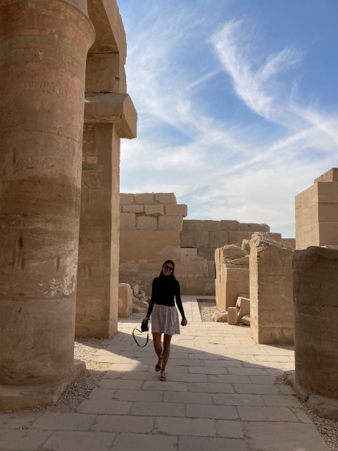 a woman in a black top and a white skirt jUy