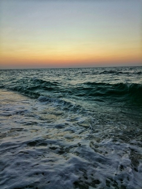 body of water under blue sky during daytime