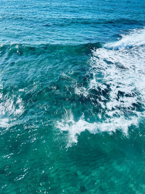 a person riding a surfboard on a wave in the ocean