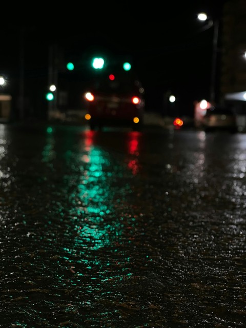 a wet street at night with traffic lights  _2_9I