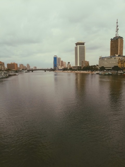 body of water near city buildings during daytime