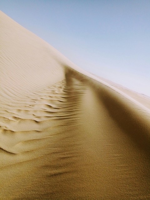 brown sand under blue sky during daytime f3PmBr