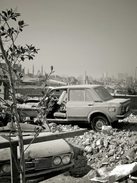 a black and white photo of a car and a truck