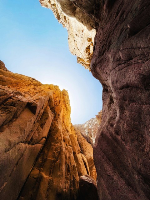 the sun is shining through a narrow canyon