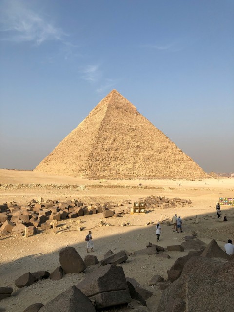 people on brown sand near pyramid during daytime