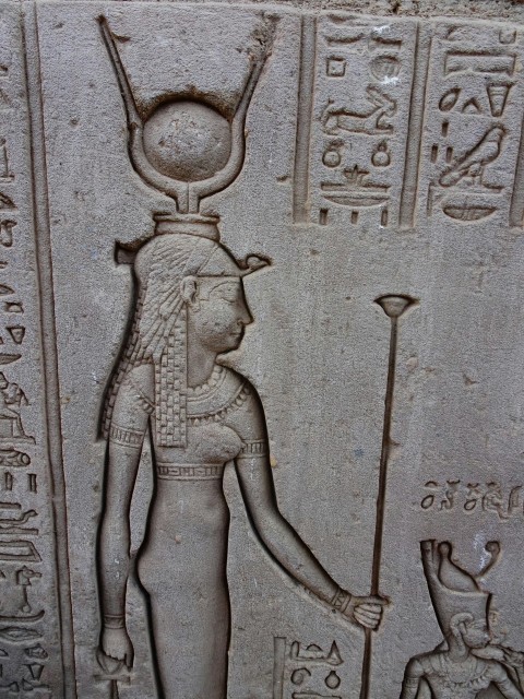 a stone with a drawing of a person holding a staff