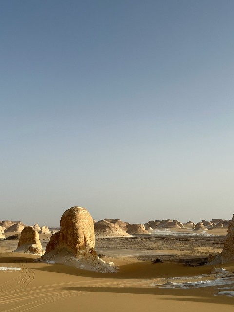 a large rock formation in the middle of a desert