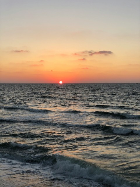 body of water during sunset