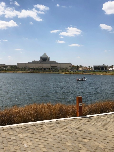 a boat on a body of water near a building eABxqp