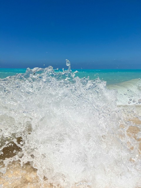 a wave crashing on a beach