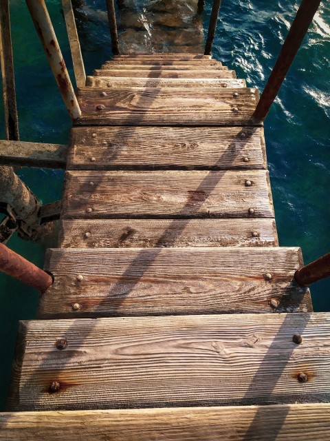 brown wooden dock over blue water