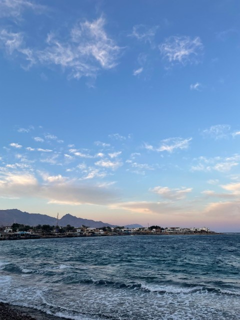 a view of a beach with waves coming in to shore