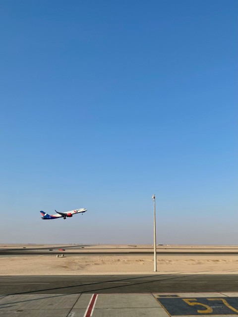 a large jetliner flying through a blue sky