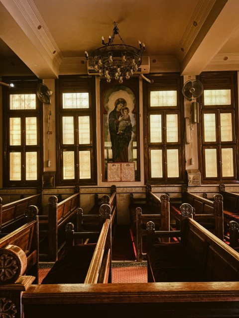 a room with a chandelier and benches