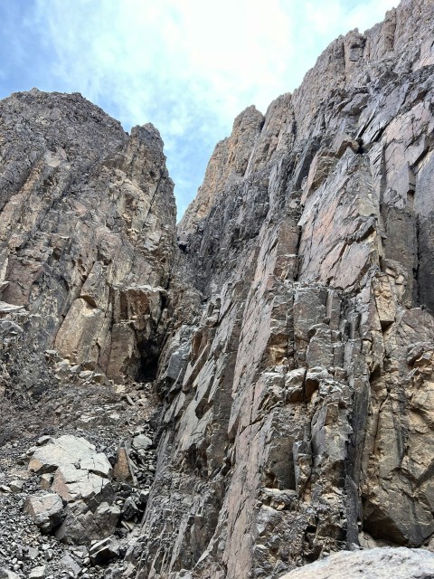 a man climbing up the side of a mountain