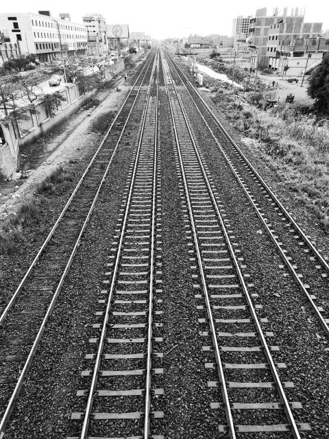 a black and white photo of a train track