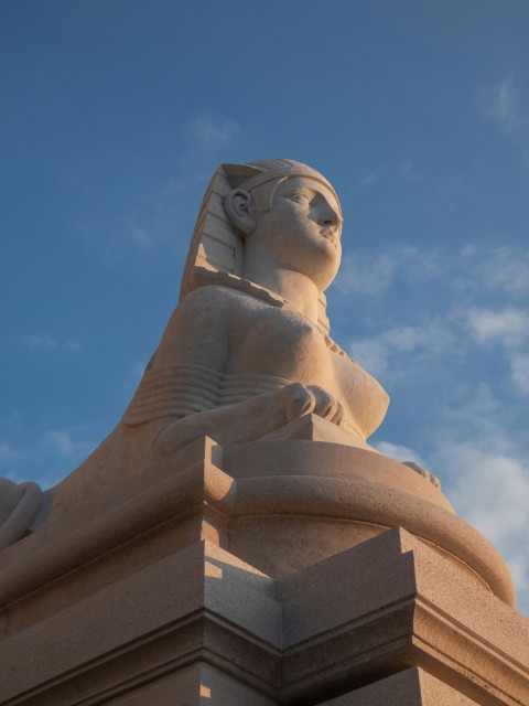 a statue of a sphinx on top of a building