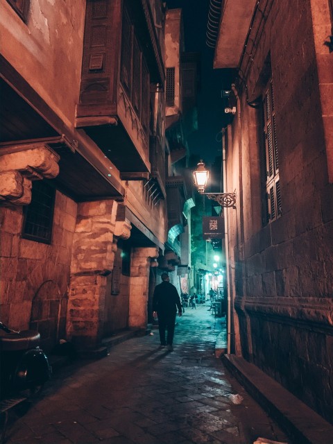 person walking near alley during nighttime