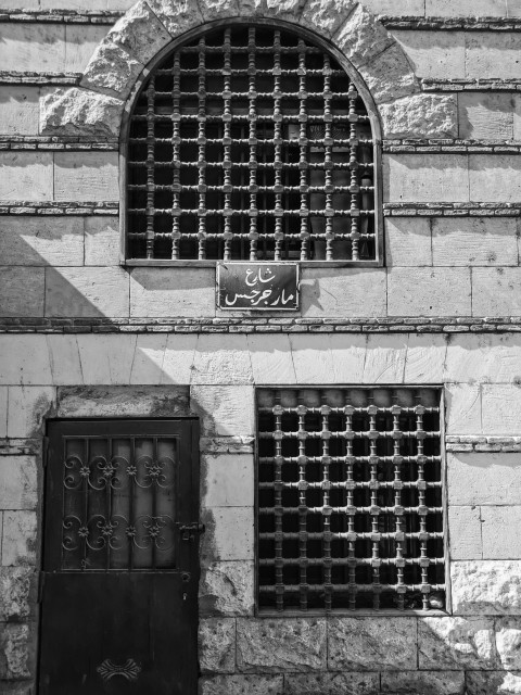 black metal window frame on gray concrete wall