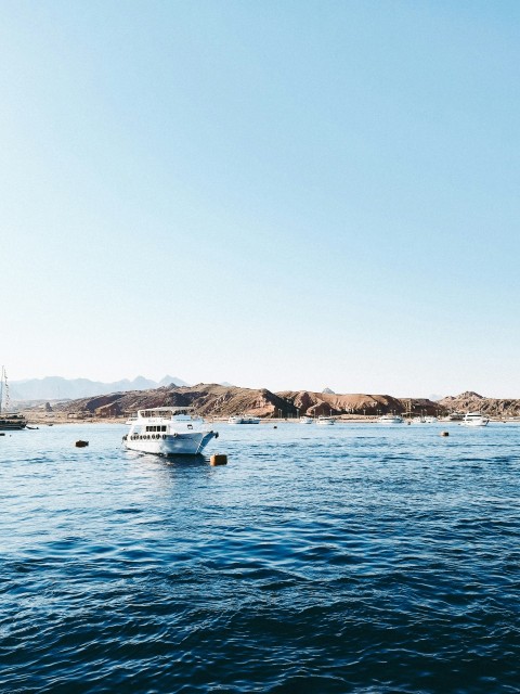 a boat floating on top of a large body of water