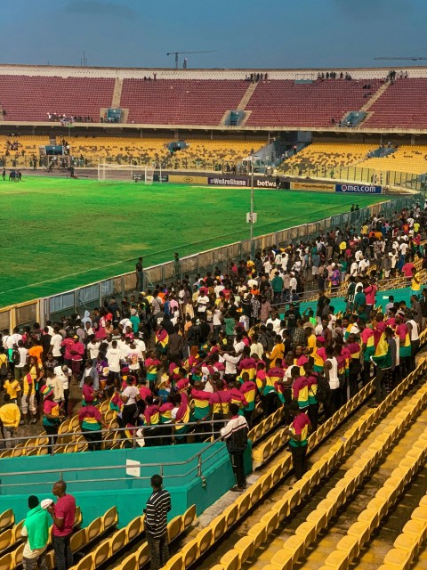 a large group of people in a stadium SMBOyVZFO