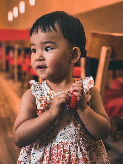 a young girl eating a sandwich