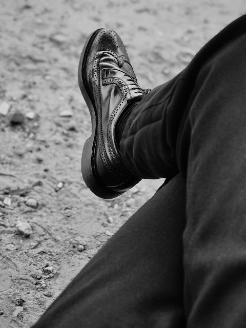 a black and white photo of a persons shoes