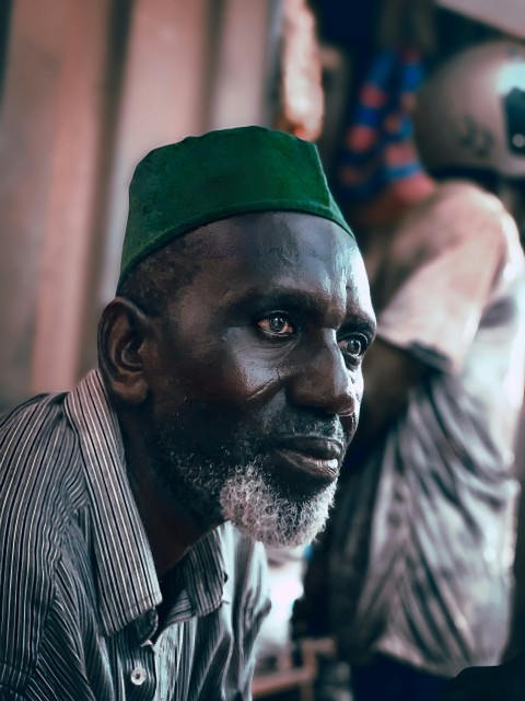 a man with a green hat on his head